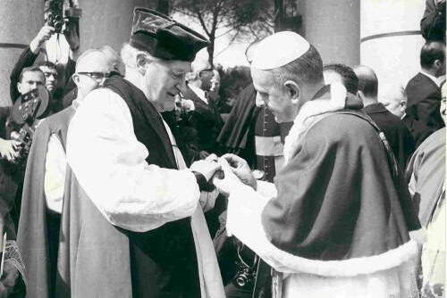 Pope Paul VI places his episcopal ring on Archbishop Michael Ramsay's finger during their 1966 meeting.