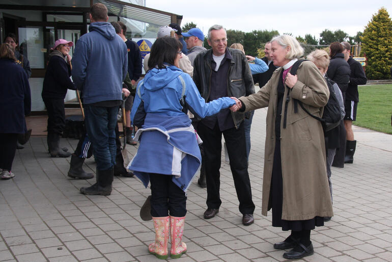 Bishop Victoria thanks one of the dozens of students who've turned out to help Kaiapoi in its days of crisis.