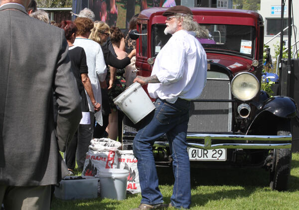 Mourners lined up to take a piece of coal and place it in the tray of the vintage Whippet truck - registration number: Our 29.