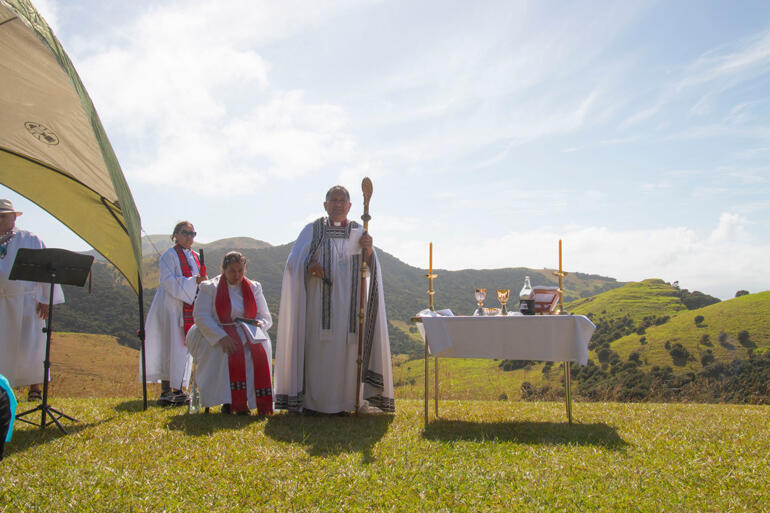Bishop Te Kitohi Pikaahu welcomes his flock to the ordination service at the 210 year old historic site in Rangihoua, Oihi, Northland.