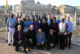 A group of multinational Anglican clergy and lay scholar stand in Romes