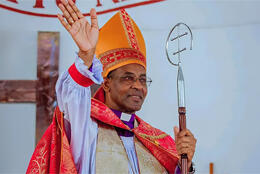 Primate of Burundi waves in episcopal robes and mitre
