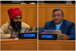 A Kanak leader and Pacific Council of Churches Secretary sits at desks in a United Nations hall