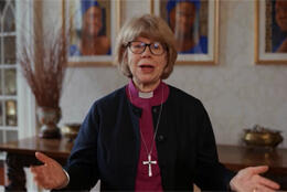 ABC Sarah Mullally stands in grandly furnished room with three paintings of African women