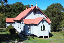 A 19th century weatherboard church stands in a grassy field