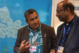 PCC Secretary Rev  James Bhagwan and WCC General Secretary Prof Jerry Pillay talk in front of a Pacific map 