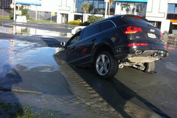 A car sinks into liquefaction following the latest aftershocks in Christchurch. Photo: Tim Kelleher