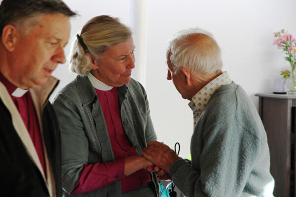 Grace and courage in adversity - a Churchill Courts resident farewells Bishop Victoria Matthews. Archbishop David Moxon is at left.