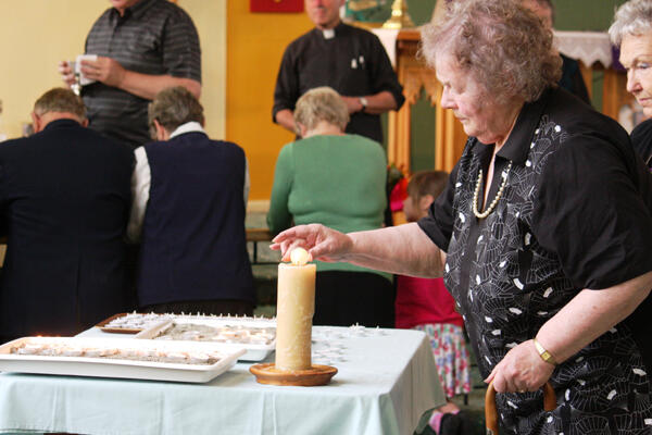 Lighting a candle - a way for West Coasters to remember, a sign of their prayers, a token of their love.