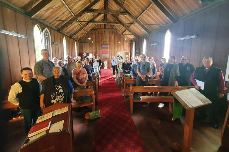 (L)Rev Cruz Karauti-Fox and (R)Archbishop David Moxon flank pilgrims at St Paul's Rangiaowhia, one of the 2023 Anglo-Catholic Hui pilgrimage sites. (L)Rev Cruz Karauti-Fox and (R)Archbishop David Moxon flank pilgrims at St Paul's Rangiaowhia, one of the 2023 Anglo-Catholic Hui pilgrimage sites.