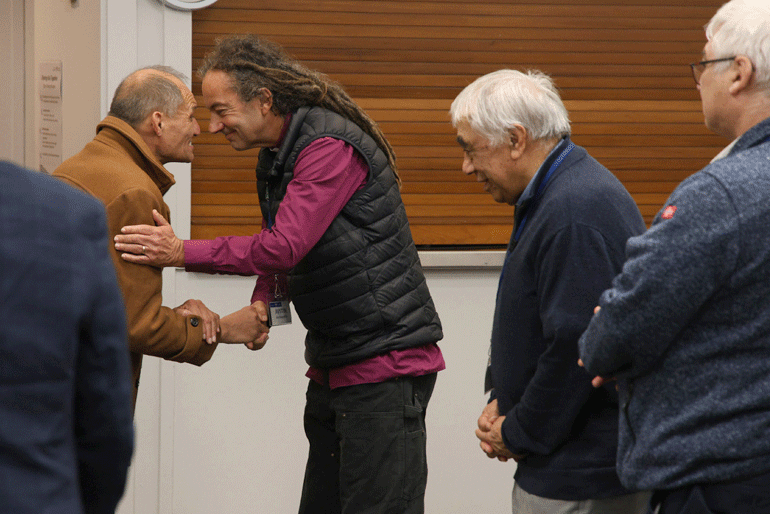 The Reverend Leo Te Kira and Archbishop Justin Duckworth greet one another in a hongi as the Reverend Don Rangi looks on.