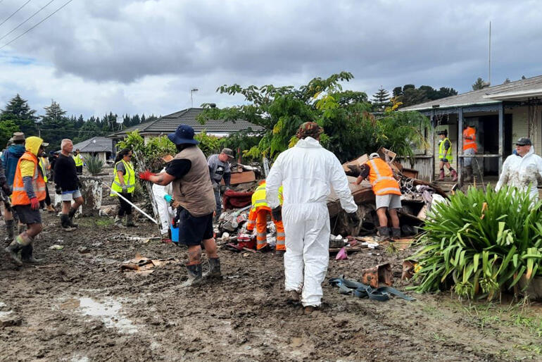 Volunteers organised by Omahu Marae help local whānau clean out silt and damaged belongings from inundated homes.