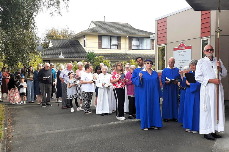 St Peter's Palmerston North brave the elements for their Palm Sunday procession.