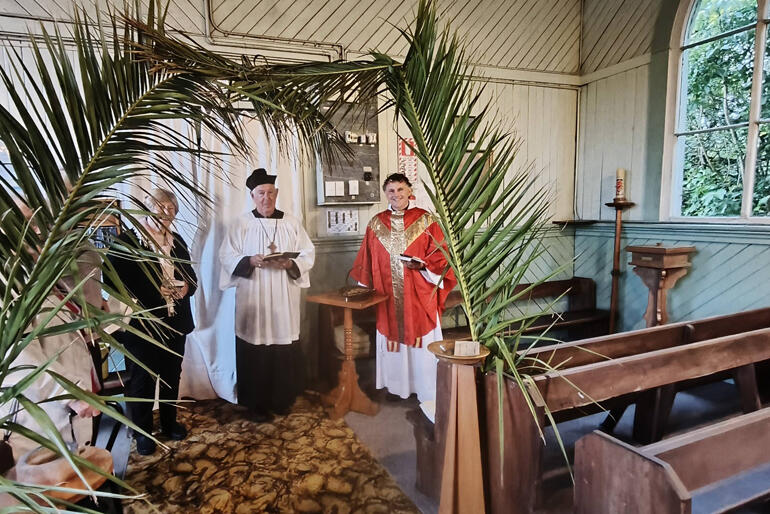 The Reverend Tim Mora pauses for a Palm Sunday photo with parishioners at St Thomas's Runanga in Westland.