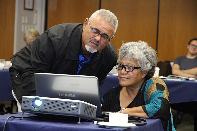 Bishop Henry Bull cues up his presentation - with some help from the Rev Jacynthia Murphy.