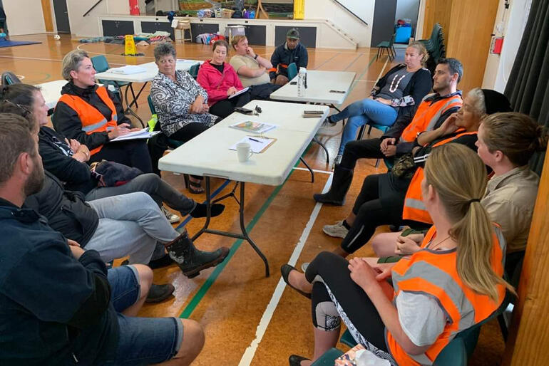 Rev Jacynthia Murphy (right 3rd from front) joins the organising team at Helensville Evacuation Centre during Cyclone Gabrielle.
