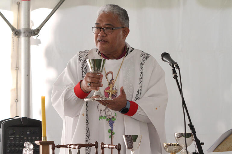 Archbishop Sione Ulu'ilakepa presides at the Eucharist taking place in the worship tent in the St John's College cloister.