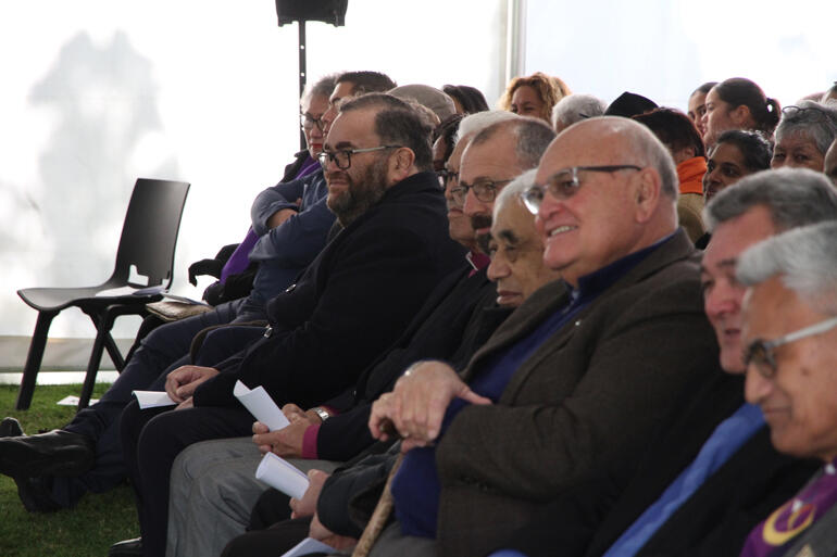 Rev Dr Hirini Kaa and the visitors' front row listen to a speaker during the pōhiri.