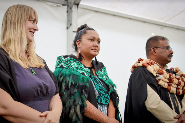 Hoani Tapu – St John's College students Cassie Lee, Channah Poutai and Daniel Sahayam stand among the graduates at this year's College pōwhiri.