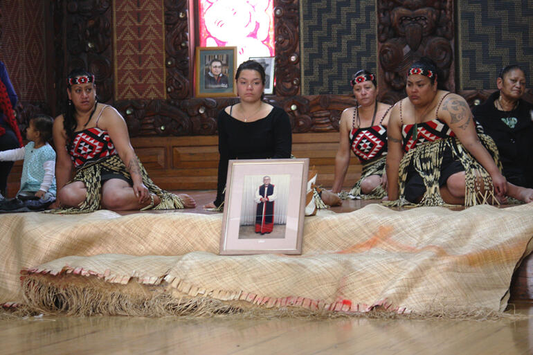 A portrait of the late Archbishop Jabez Bryce is flanked by Maori women during the General Synod powhiri.