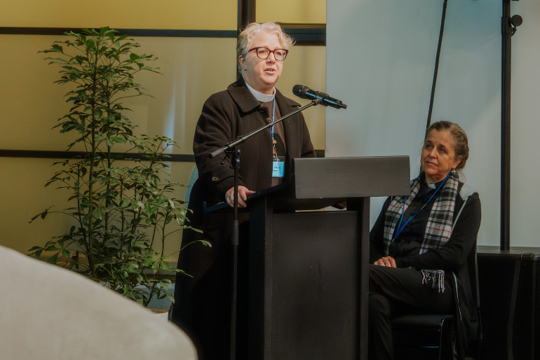 Rev Clare Barries calls for gender caucuses as Rev Dr Anne van Gend looks on.