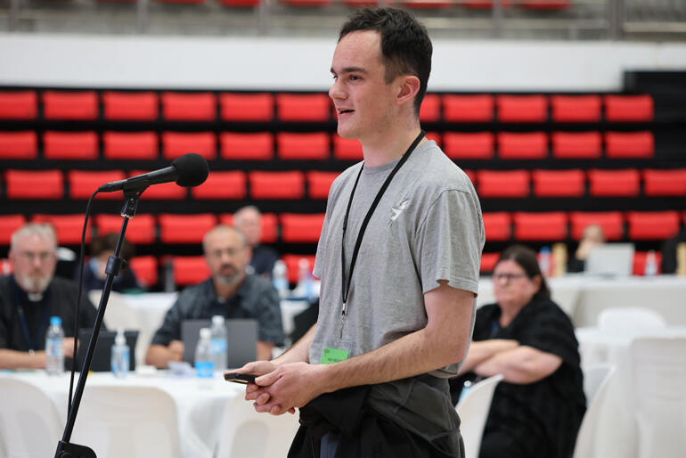 Diocese of Christchurch youth delegate Jack Hollis stands to affirm Motion #10 on AI technologies.