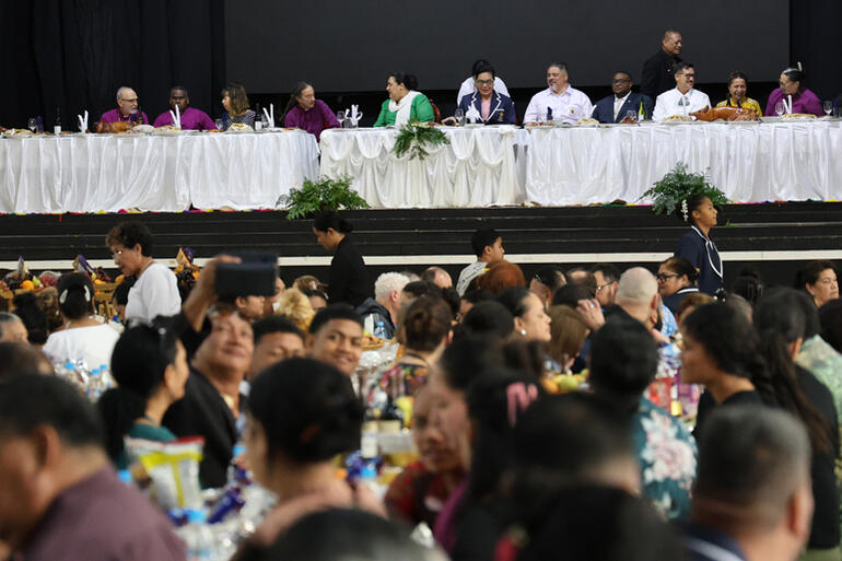 Dignitaries and people enjoy the feast together.