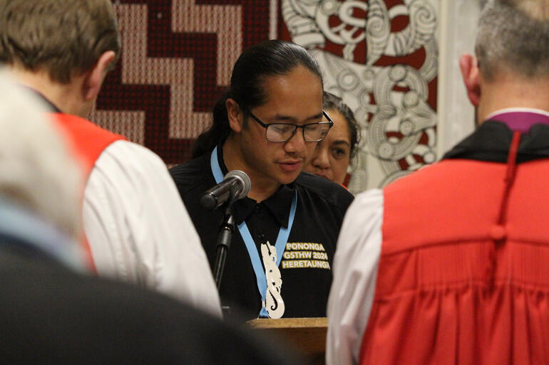 Pononga (Synod youth steward) Apache Hānara reads scripture during worship in Kahukuranui.