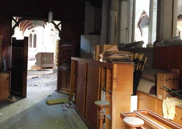 View of the nave from the choir-room corridor at the east end. The portable organ console is just below the chancel.