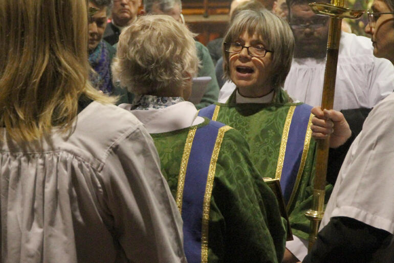 Rev Jenny Dawson reads the gospel during the opening mass.