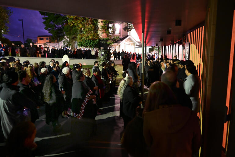 The crowd gathers for karakia as Te Whare Hononga opens at dawn on 13 April 2023.