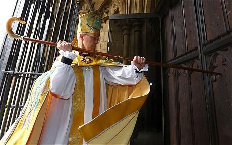 Archbishop Welby strikes three times on the West Door of Canterbury Cathedral. Photo: Daily Telegraph