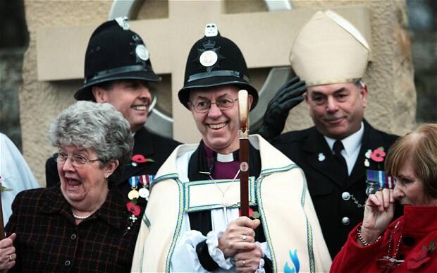 Bishop Justin Welby, soon to become Archbishop of Canterbury, swaps headgear with PC Keith Todd in Sedgefield, Durham.