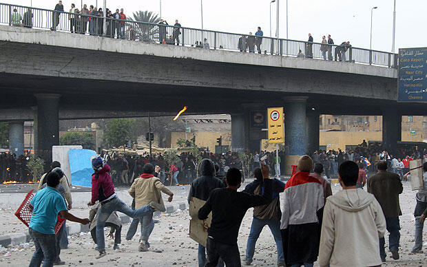 Murbarak supporters pelt anti-government demonstrators in Cairo.