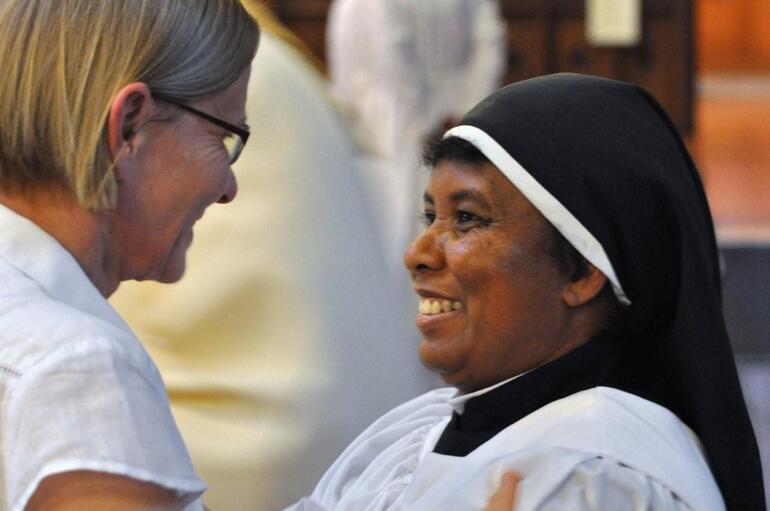 Dr Eeva John, Academic Register of Trinity College, Bristol, congratulates St Veronica - who is studying at Trinity College.