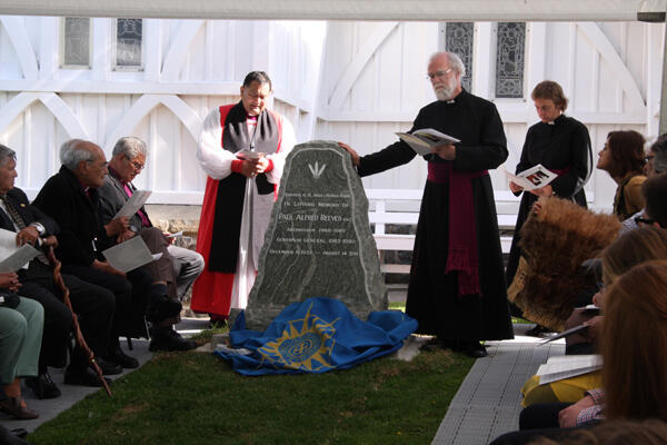 The Archbishop of Canterbury lays a hand in blessing upon the headstone of Sir Paul Reeves.