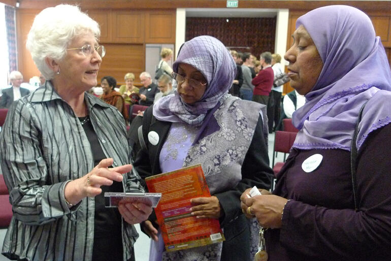 Jocelyn Armstrong (left) shares her 'Discovering Diversity' textbook with two Aucklanders at the book's launch in 2009.  