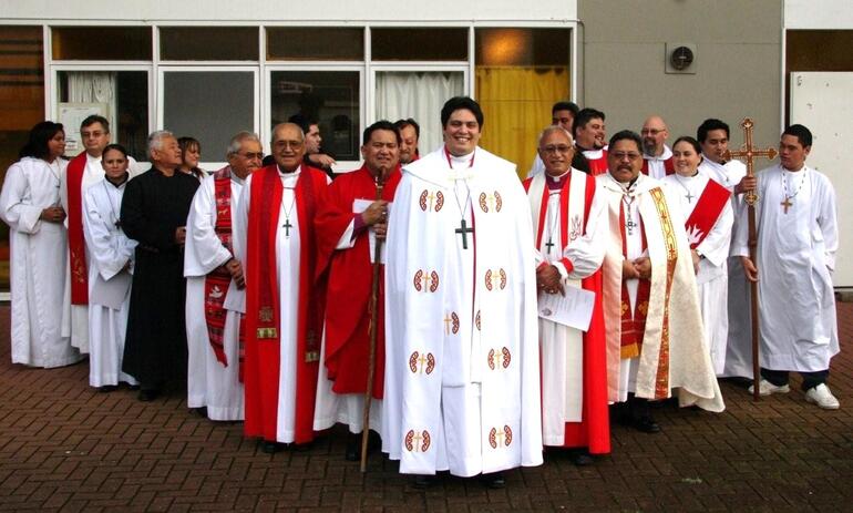 The Rev Michael Tamihere, priest, and some of his supporters.