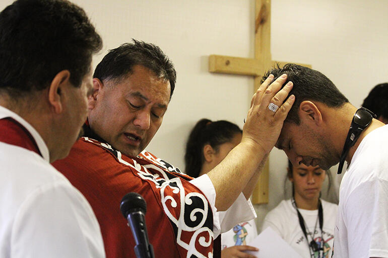 Bishop Kito Pikaahu confirms Roger Tarei, who was one of the seven confirmation candidates. Bishop Kito Pikaahu confirms Roger Tarei, who was one of the seven confirmation candidates.