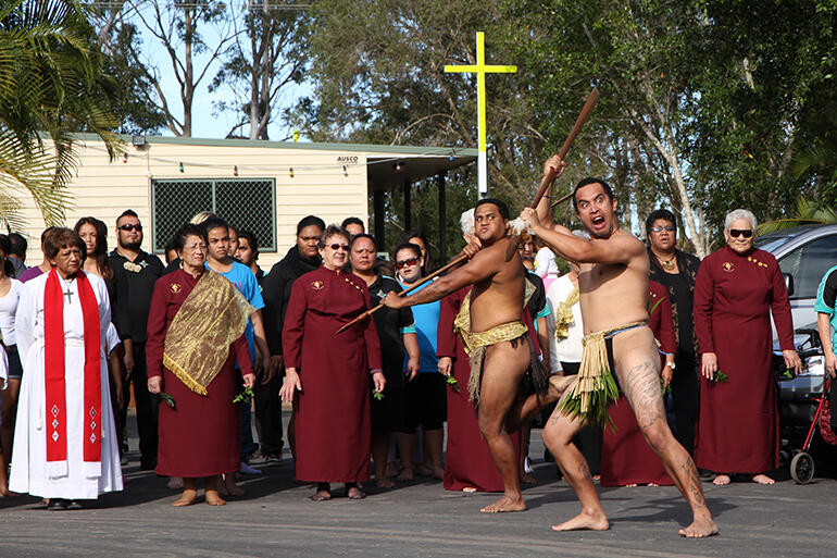 The two warriors leap out in front of the Piripane crew. In the Queensland colours are Heni Te Kawa (left) Adrienne Lewis and Margaret McLennan. The two warriors leap out in front of the Piripane crew. In the Queensland colours are Heni Te Kawa (left) Adrienne Lewis and Margaret McLennan.