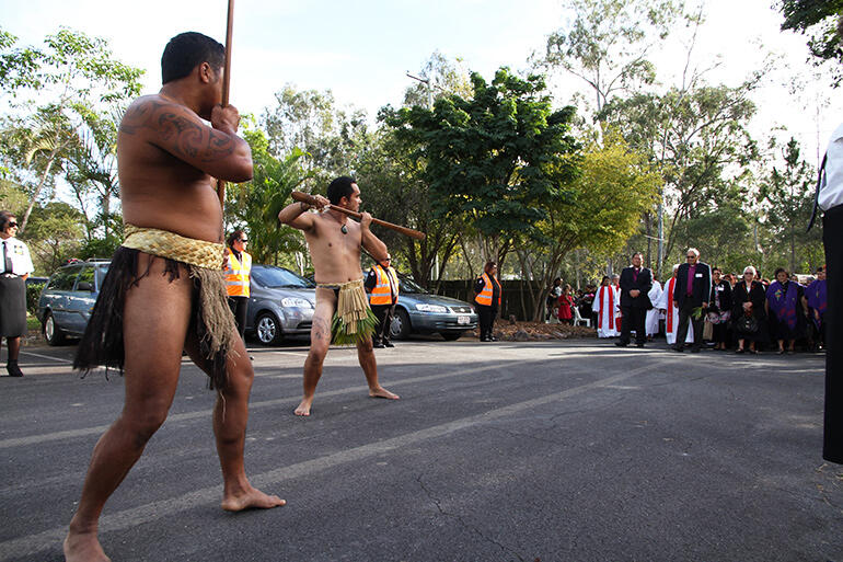 With Archbishop Brown having picked up the frond that signifies peace, the warriors lead the manuhiri on towards the powhiri. With Archbishop Brown having picked up the frond that signifies peace, the warriors lead the manuhiri on towards the powhiri.