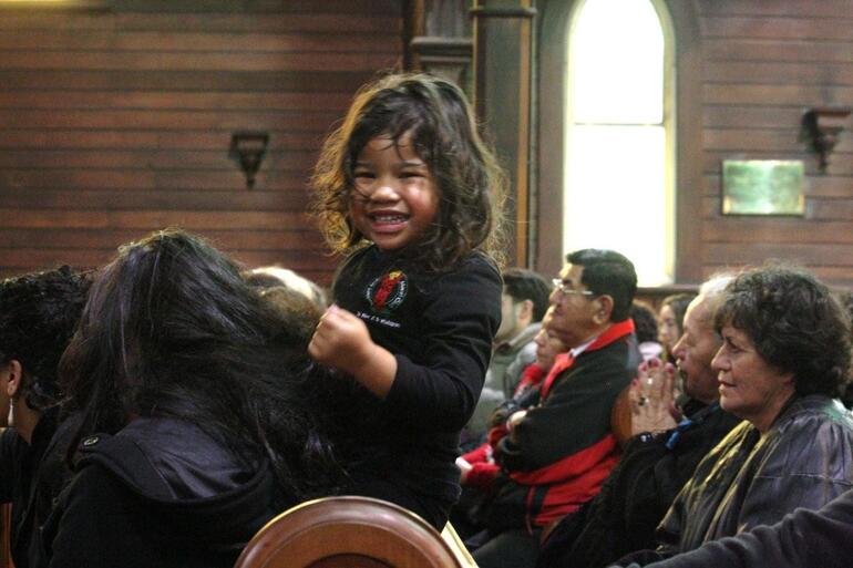 Kiyanah Paenga arranges her own entertainment during presentations in the church.