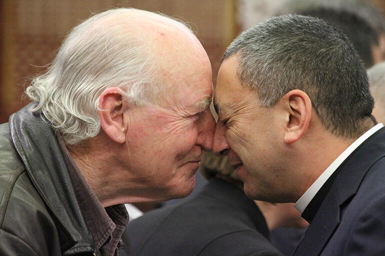 Bishop George Connor exchanges the hongi with Katene.