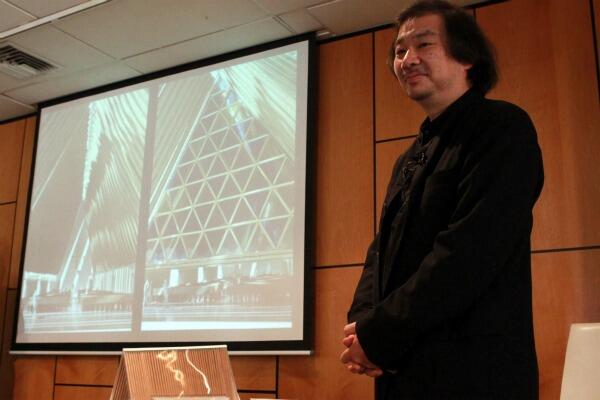Japanese architect Shigeru Ban with a slide of his cardboard cathedral. Photo: The Press
