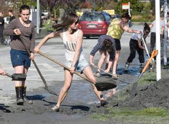 Students help to clear a Christchurch street. Picture, Mark Mitchell in the NZ Herald.