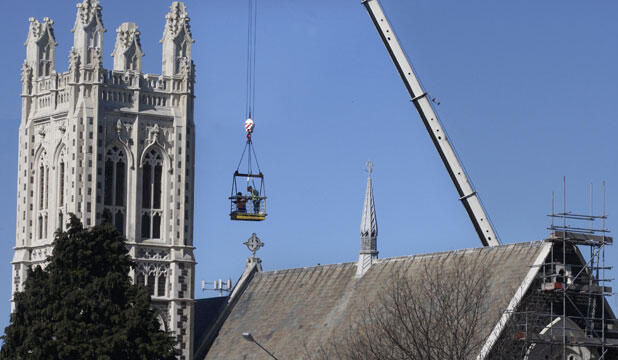 A worker removes crosses from the roof of St Mary's, Timaru, after the September 4, 2010 earthquake. Photo: Timaru Herald