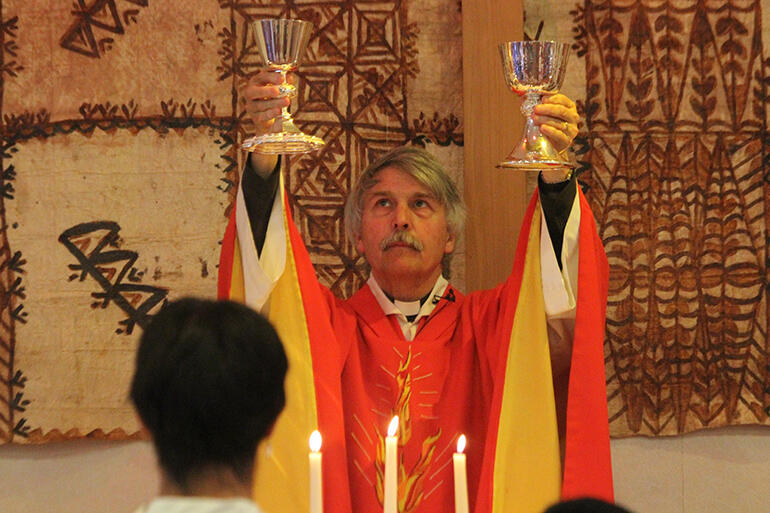 Fr Mark raises the chalices. Fr Mark raises the chalices.