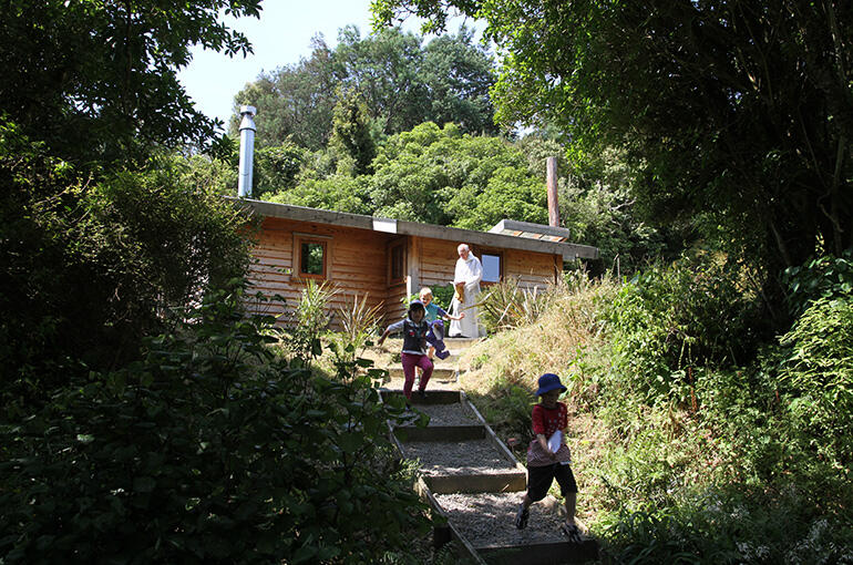 The Chapel of Tarore stands on a knoll, and is reached by a winding path through the trees from the main community houses.