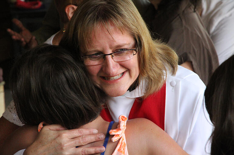 The Rev Karen Kemp - our new priest and Dean of the Tikanga Pakeha students at St John's College - embraces a young friend.