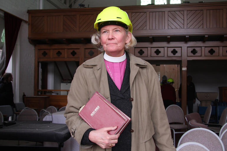 Bishop Victoria pauses before joining the crew who removed all the religious fittings and furniture from the chapel.